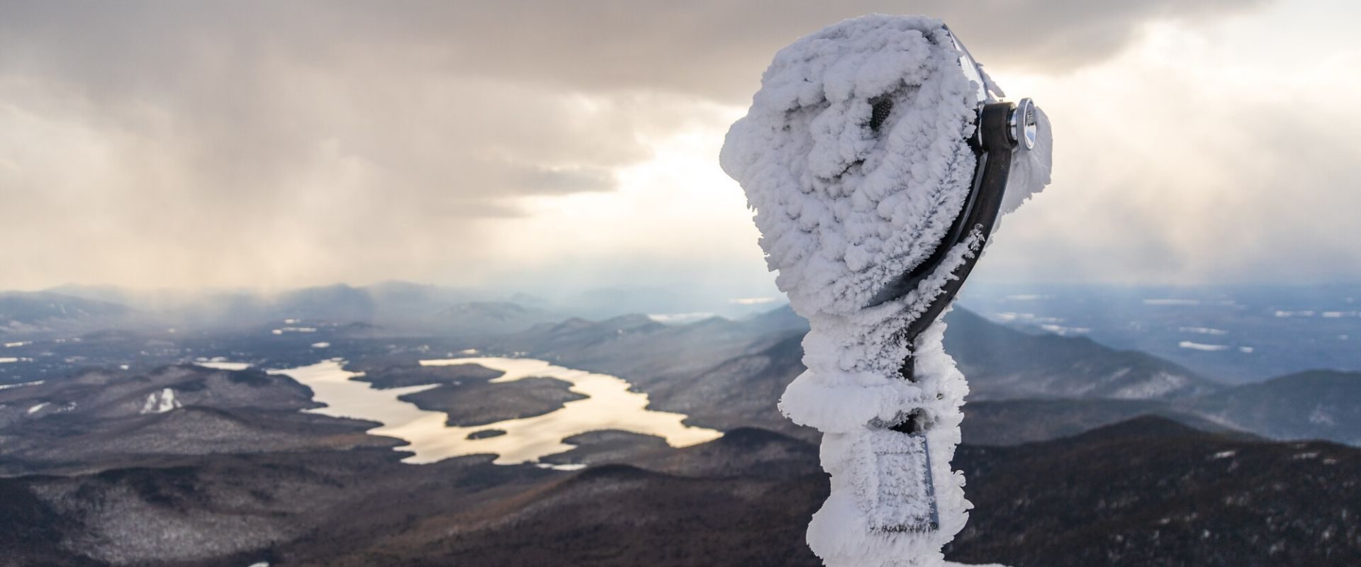 Tower viewer covered in the snow on the top of Whiteface Mountain, looking out at Lake Placid