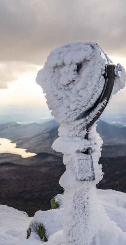 Tower viewer covered in the snow on the top of Whiteface Mountain, looking out at Lake Placid